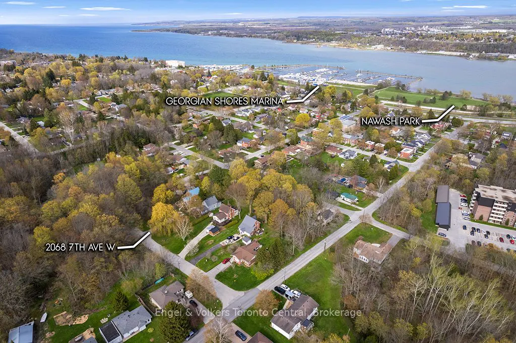 Aerial view of a residential area near Georgian Shores Marina and Nawash Park, with blue water in the background.
