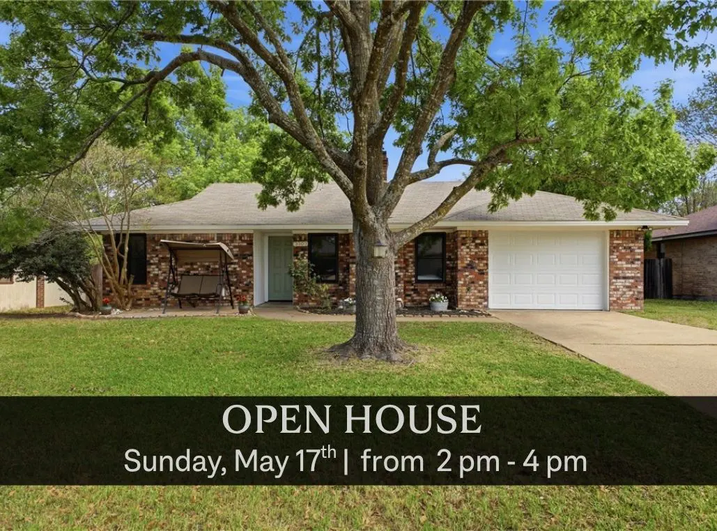 Brick house with white garage door and green door, large tree in front yard, swing on porch. Open house Sunday, May 17th, 2-4pm.