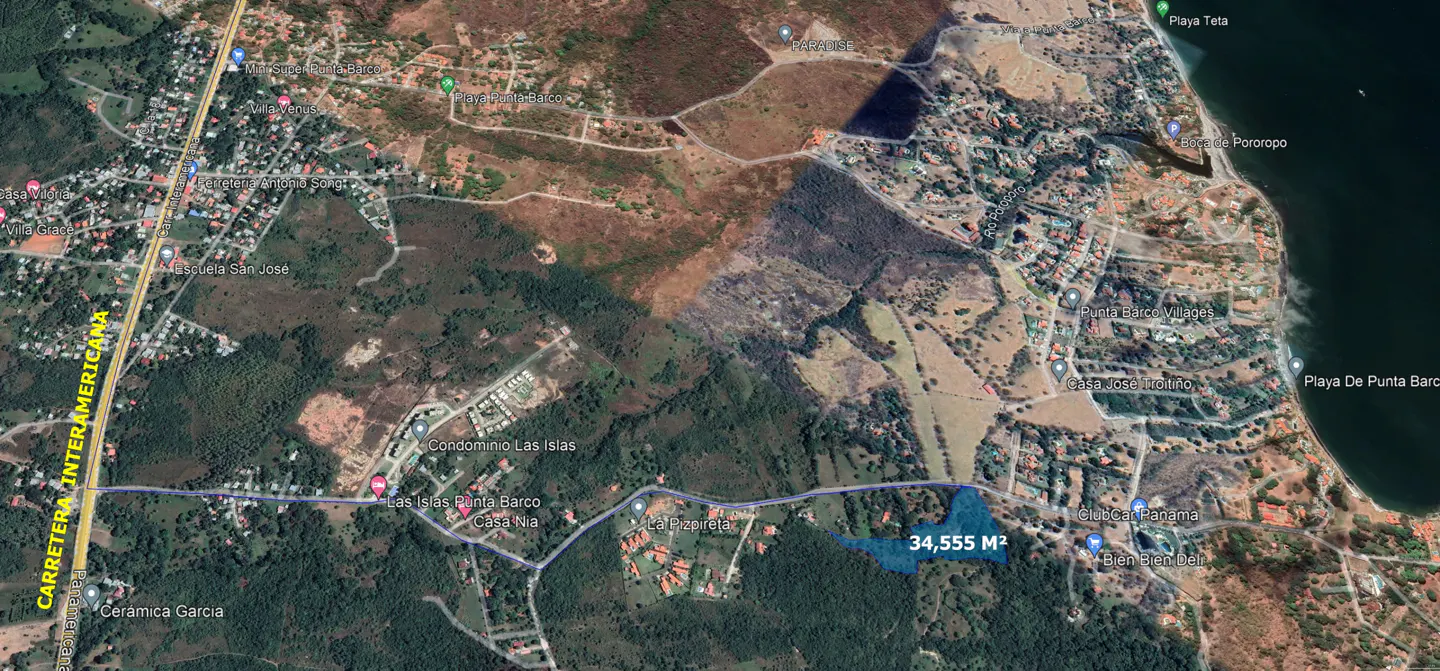 Aerial view of a 34,555 m² property near Punta Barco, Panama, bordered by lush greenery and residential areas.