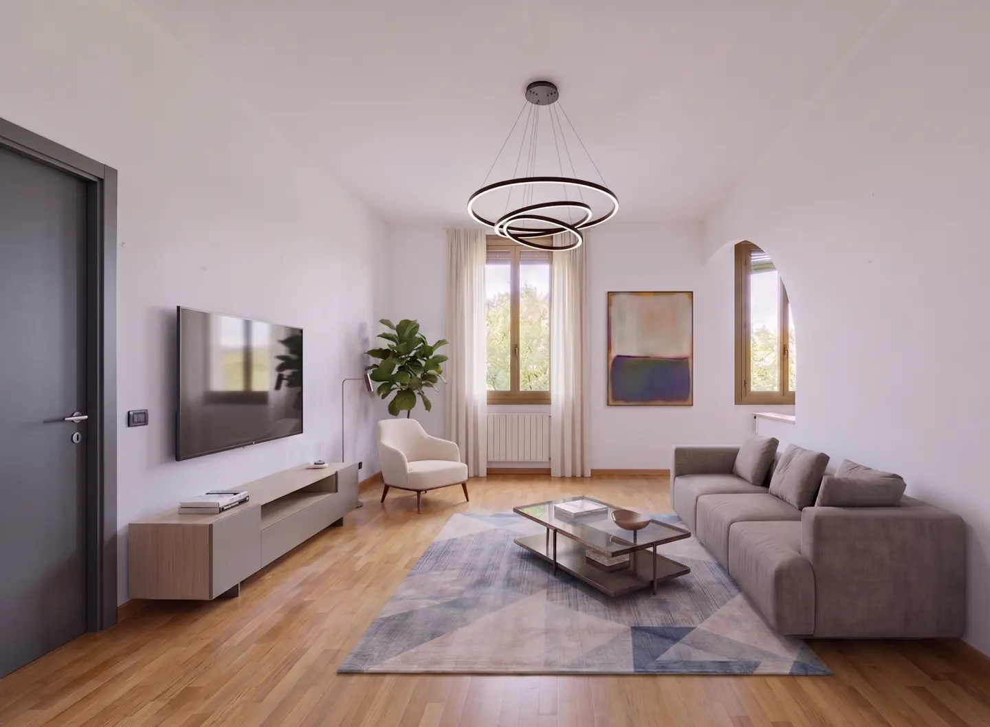 Bright living room with hardwood floors, a gray sofa, a glass coffee table, and a modern ring chandelier. A large TV is mounted on the wall.