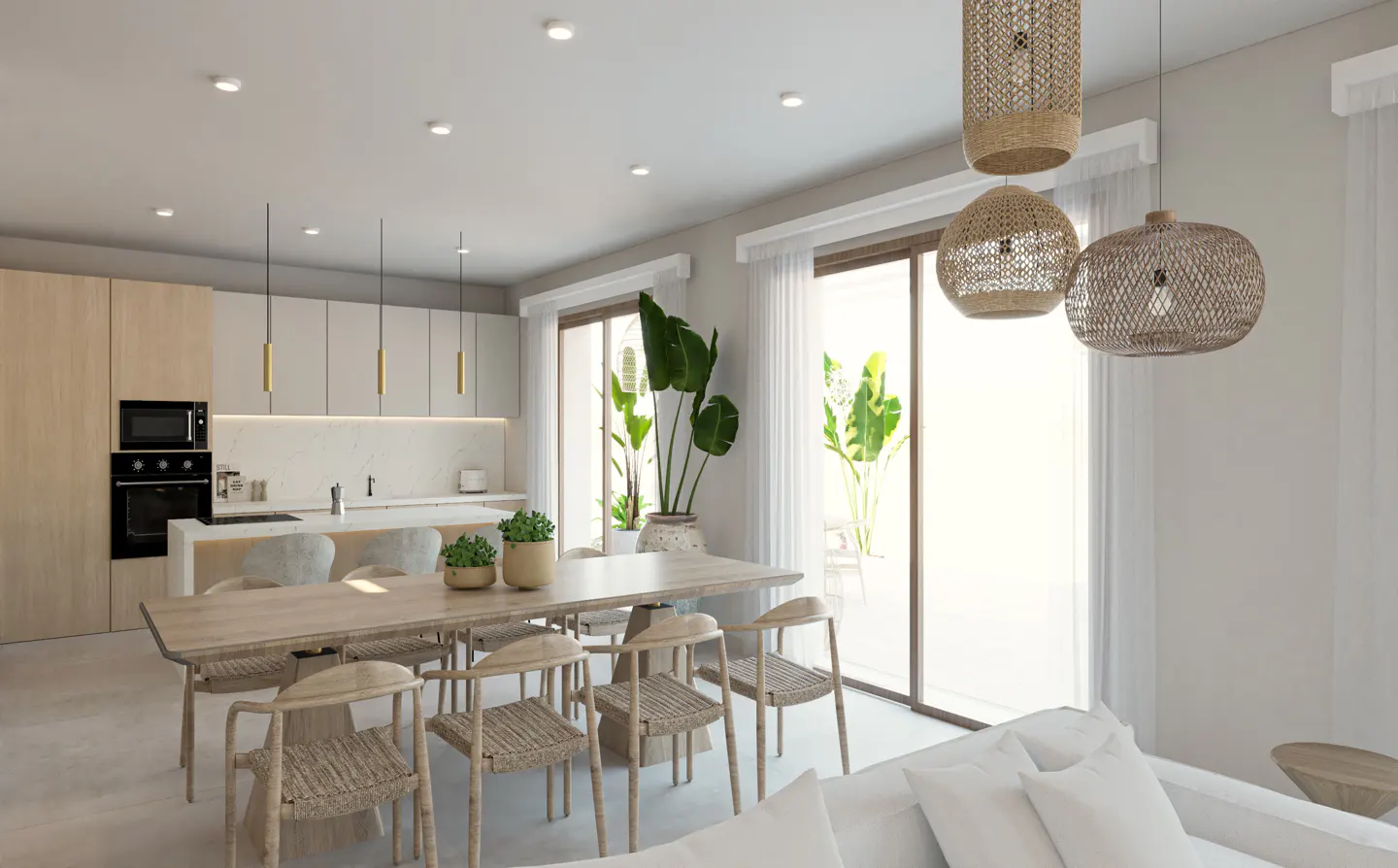 Modern open-plan kitchen and dining area with light wood tones, woven chairs, pendant lights, and large glass patio doors.