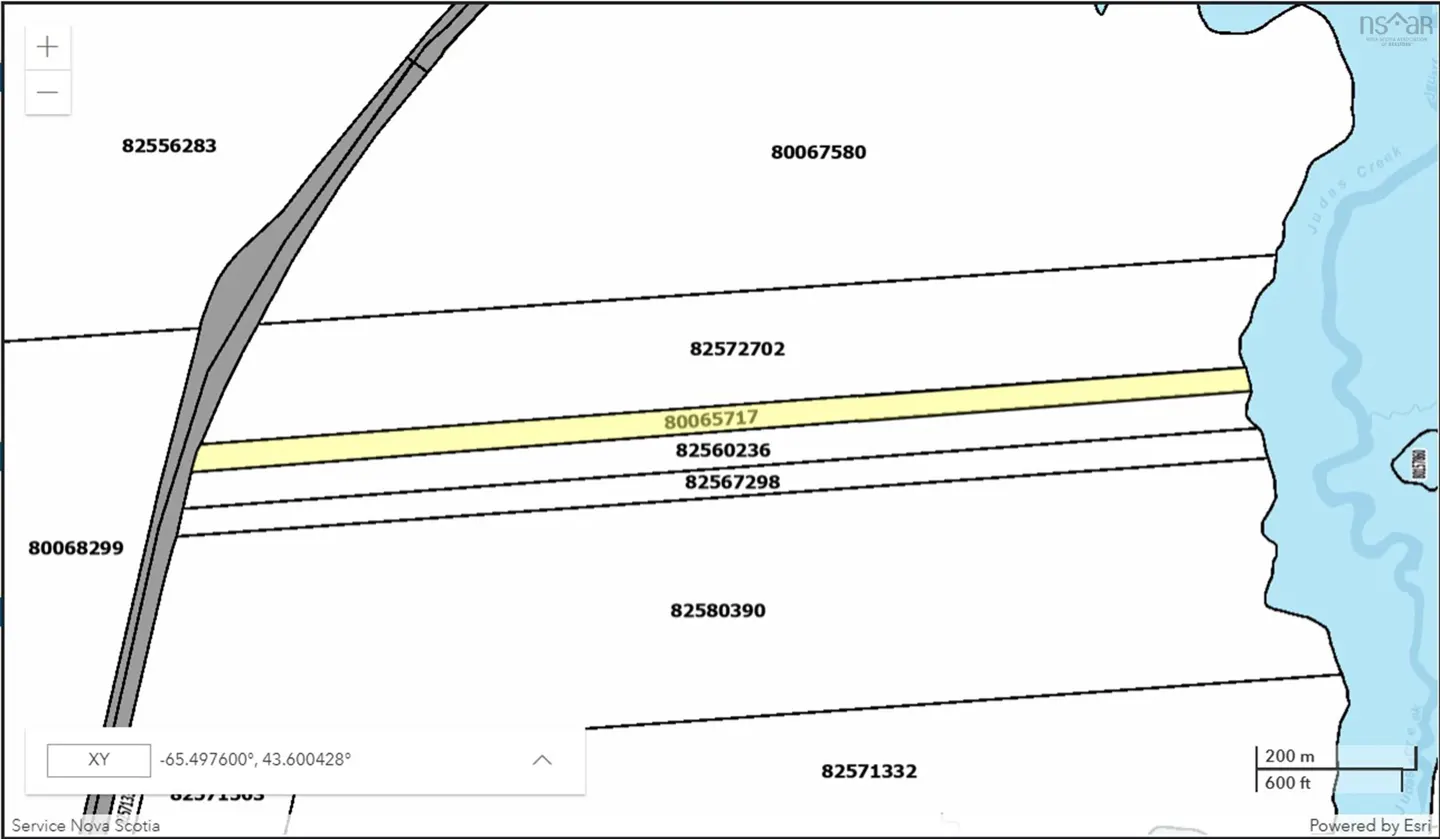 Property map showing a highlighted yellow parcel of land (PID 80065717) bordered by a road and a creek.