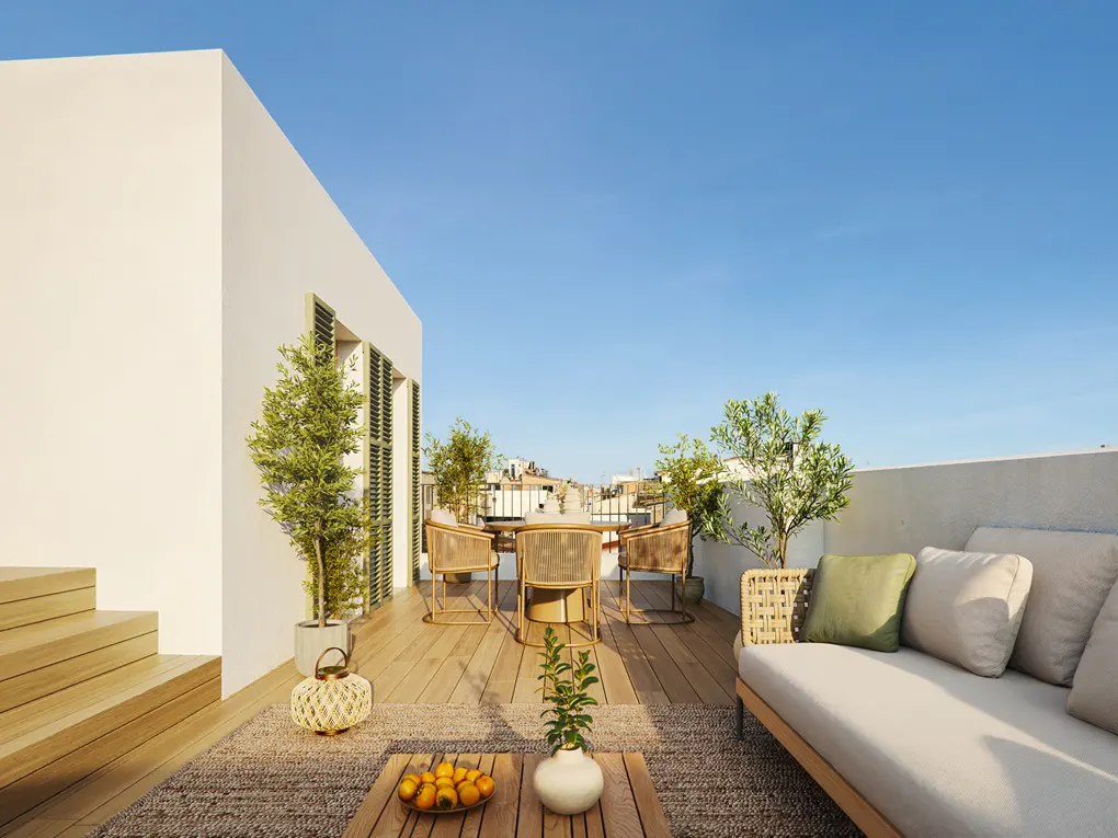 Rooftop patio with wood deck, table, chairs, and sofa. Potted trees add greenery. Blue sky background.
