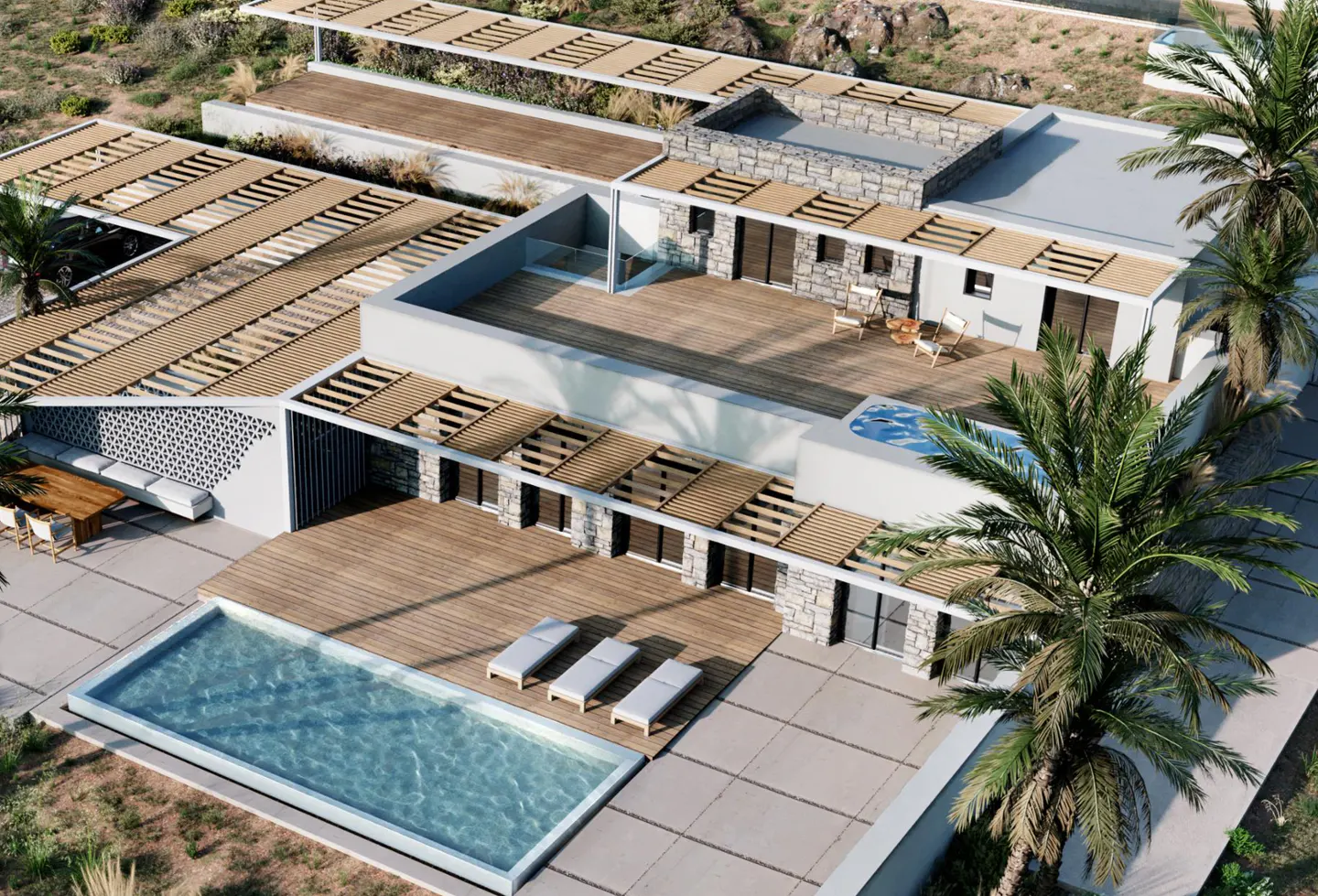 Aerial view of a modern villa with stone walls, wooden pergolas, a swimming pool, and lounge chairs on a wooden deck.