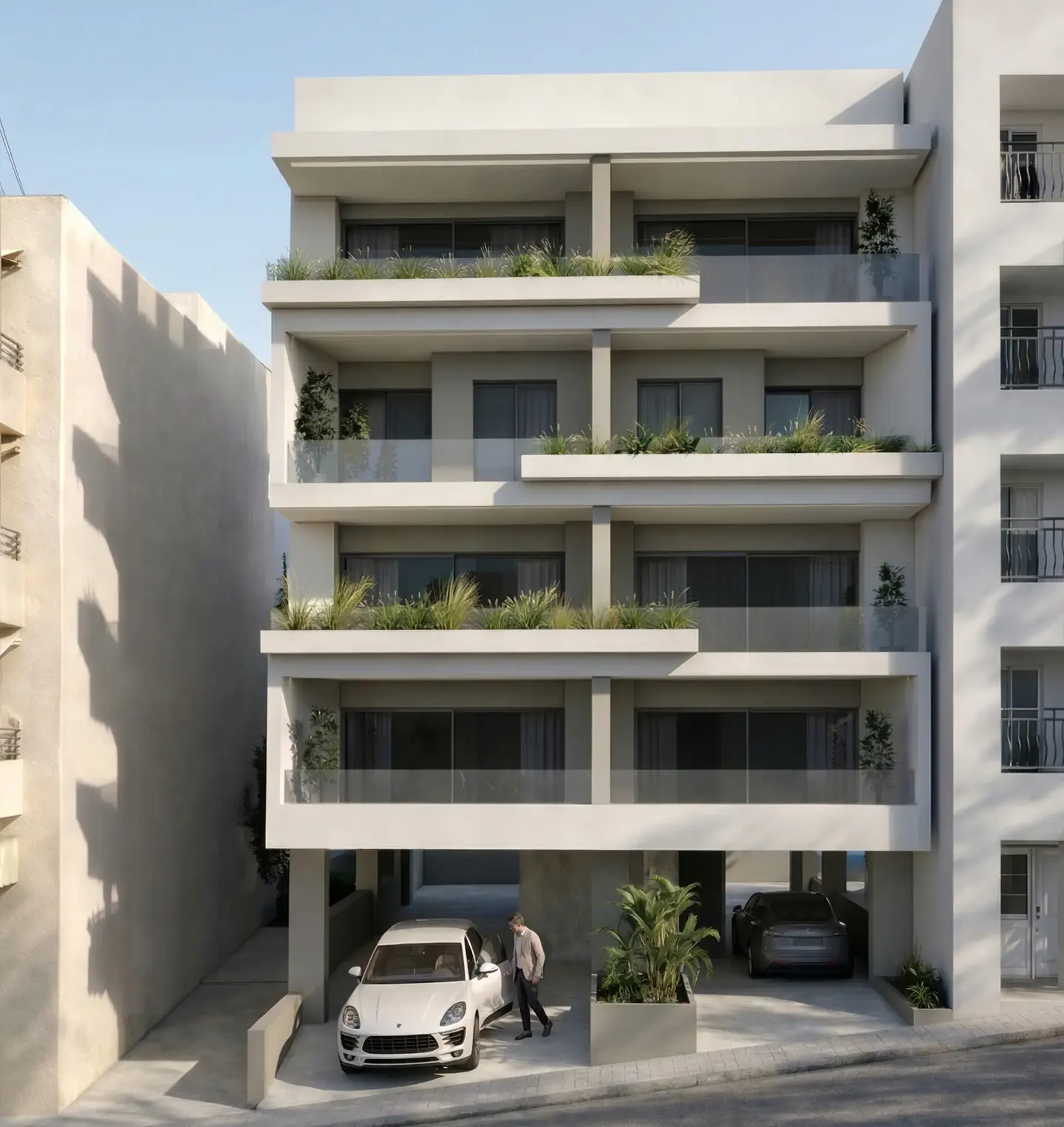 Modern white apartment building with balconies and greenery. A man exits a white car parked underneath.