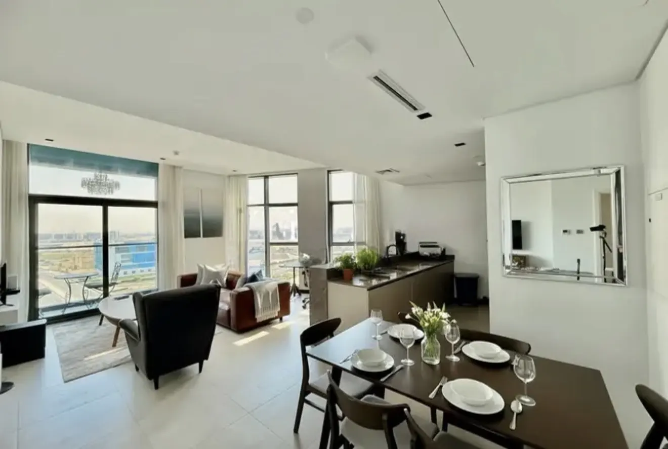 Bright, modern apartment with a dining table set for six, a living room with a view, and a sleek kitchen.