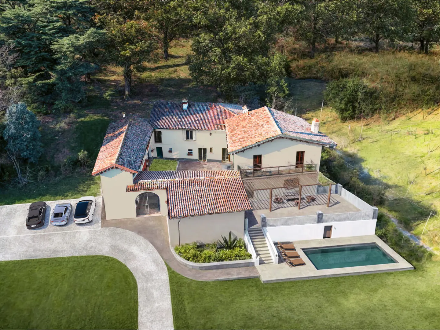 Aerial view of a cream-colored villa with a terracotta roof, swimming pool, patio, and three cars parked in the driveway.
