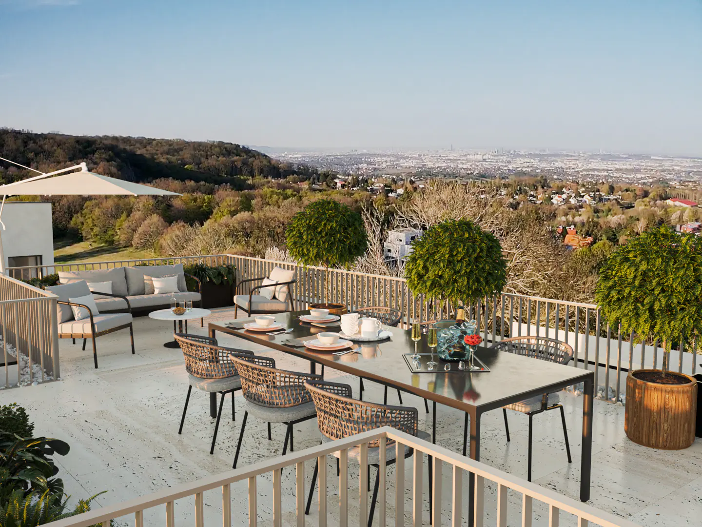 Outdoor patio with dining table, chairs, and lounge area overlooking a green landscape and distant city skyline.