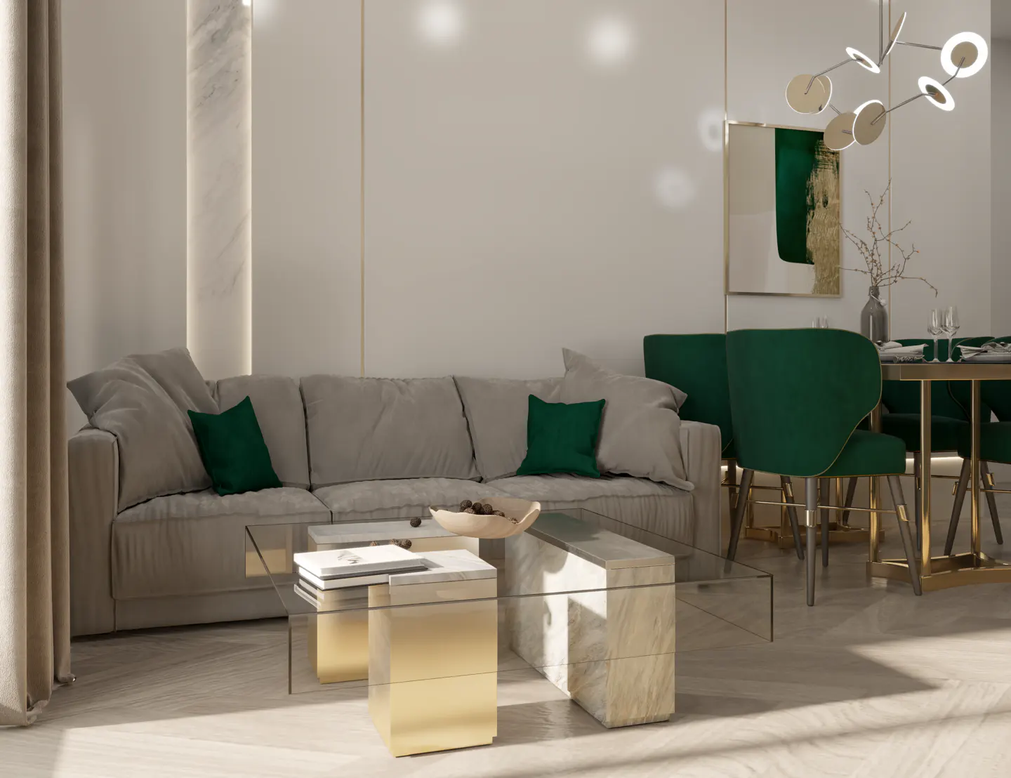 Living room with a gray sofa, green pillows, and a glass coffee table. Emerald green dining chairs and a modern chandelier are in the background.