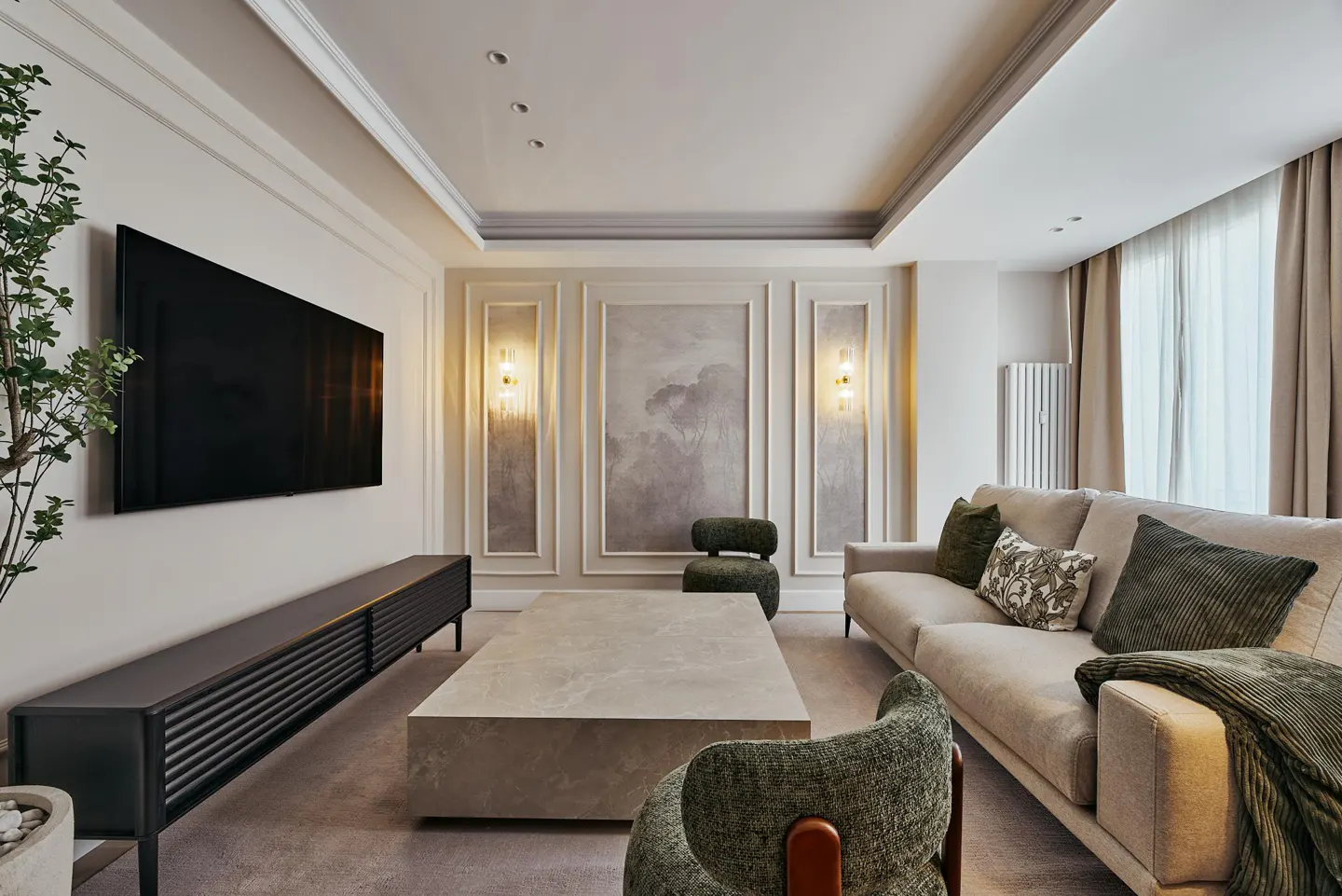 Modern living room with a beige sofa, stone coffee table, dark media console, wall sconces, and a large wall-mounted TV.
