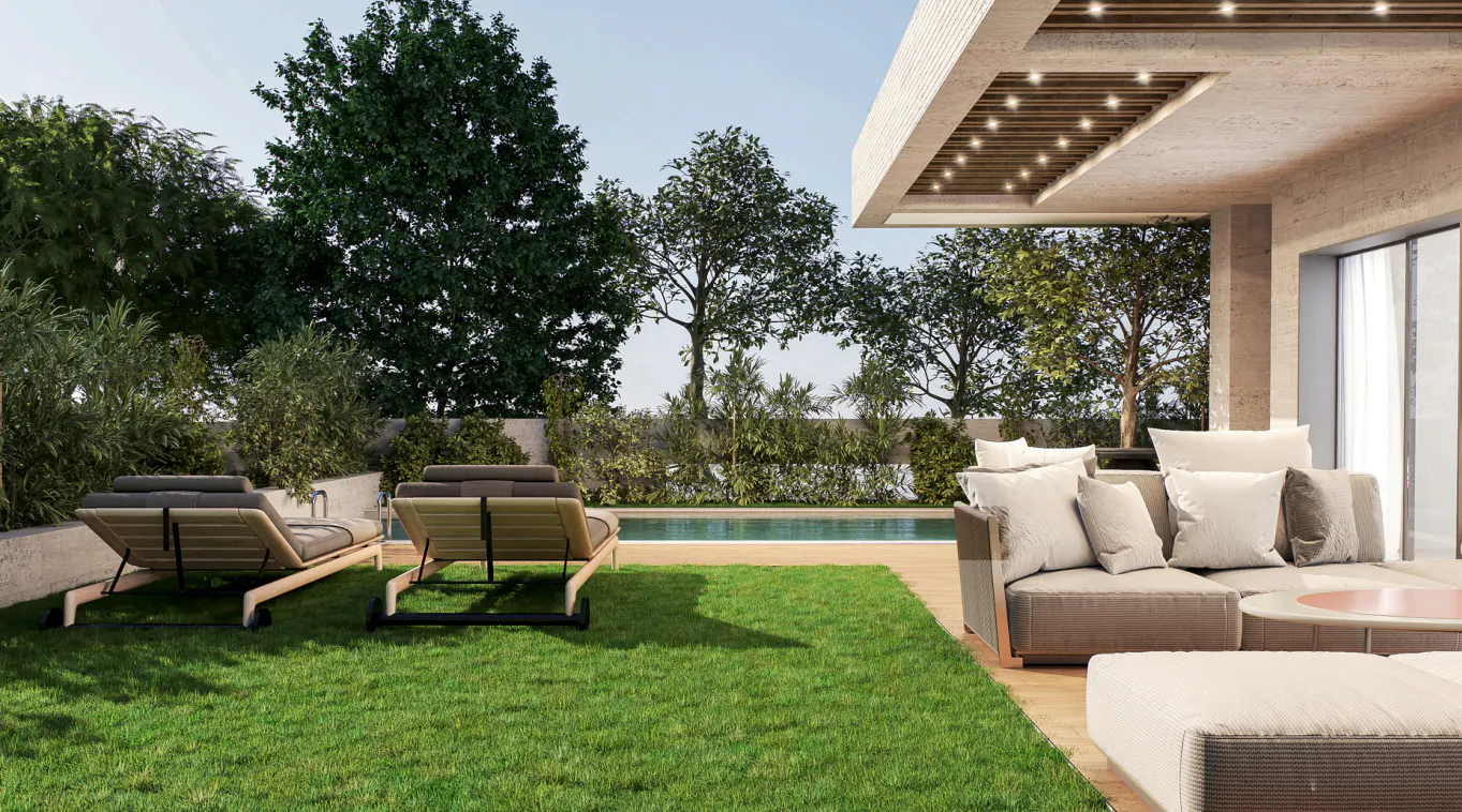 Outdoor patio with two lounge chairs on green grass, a pool, and a beige sofa with white pillows under a covered patio.