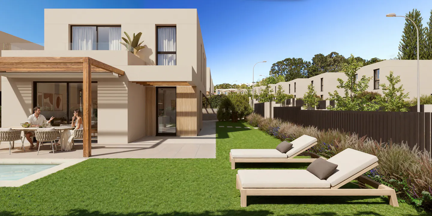 Modern home exterior with a couple dining on the patio, a pool, and lounge chairs on the lawn.