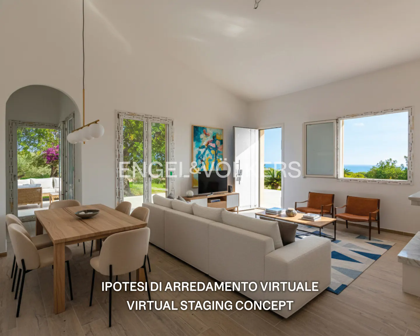 Bright, open living space with a dining table, white sofa, and ocean views through large windows. Modern interior design.